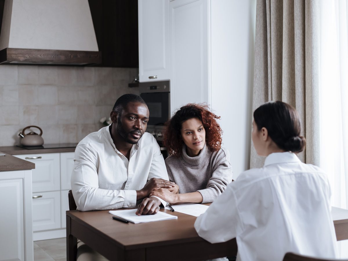 Family and support worker in discussion around a kitchen table