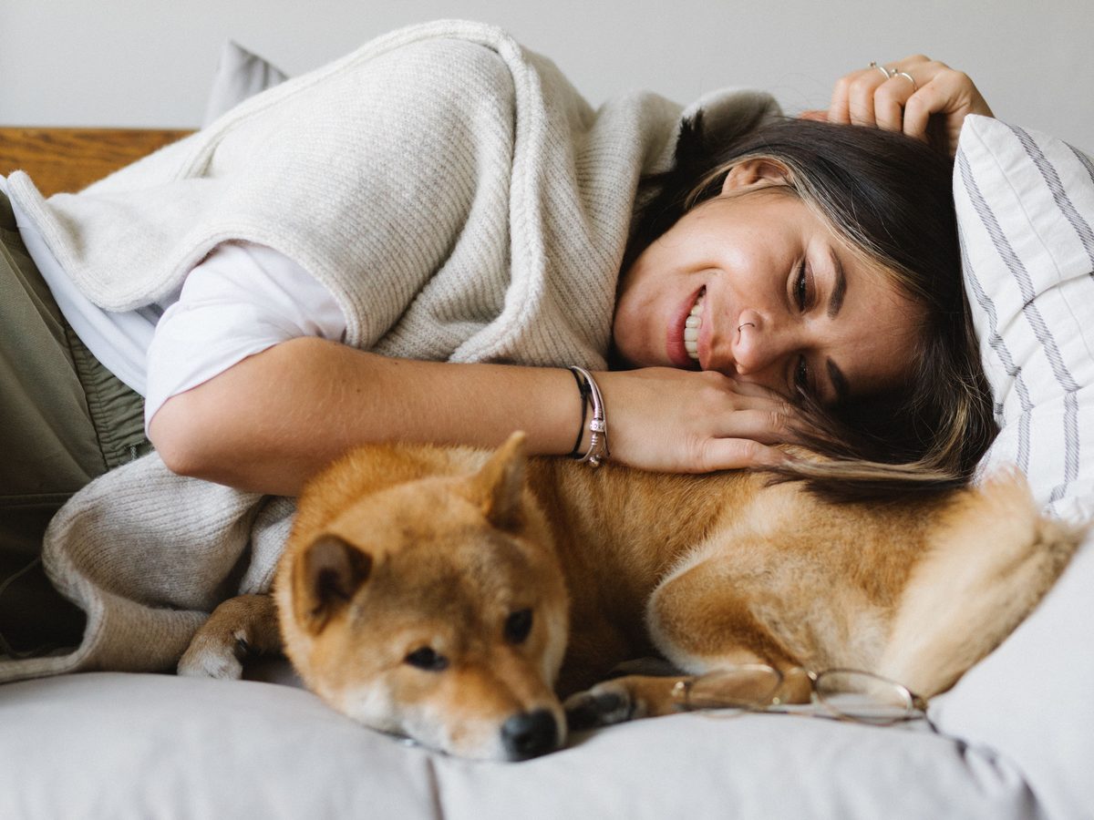 Curled up on the sofa with a much-loved dog
