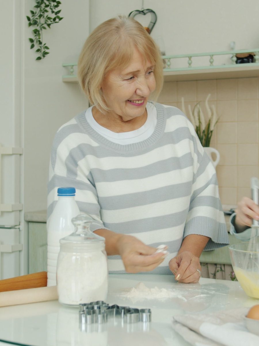 A grandmother and granddaughter baking together in the kitchen