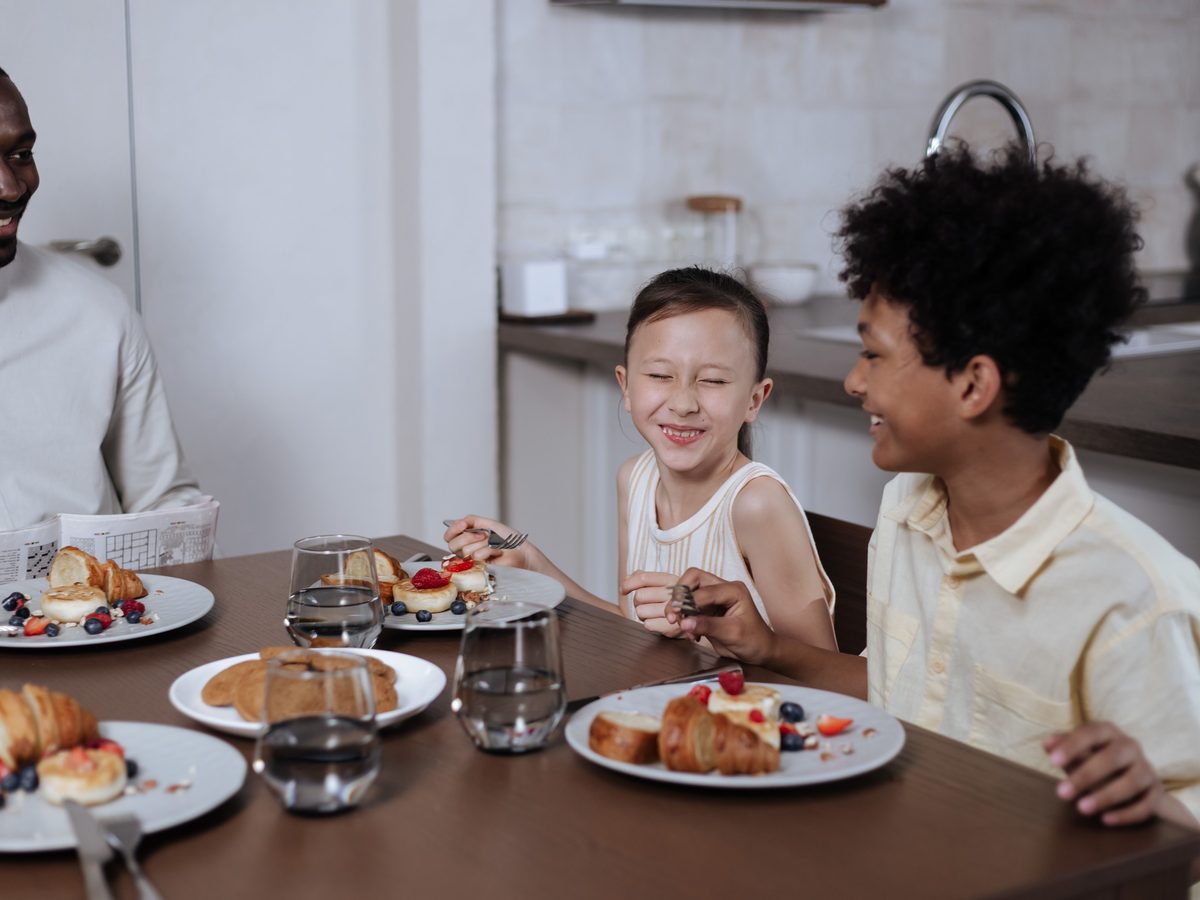 Family sharing breakfast and a laugh around the table