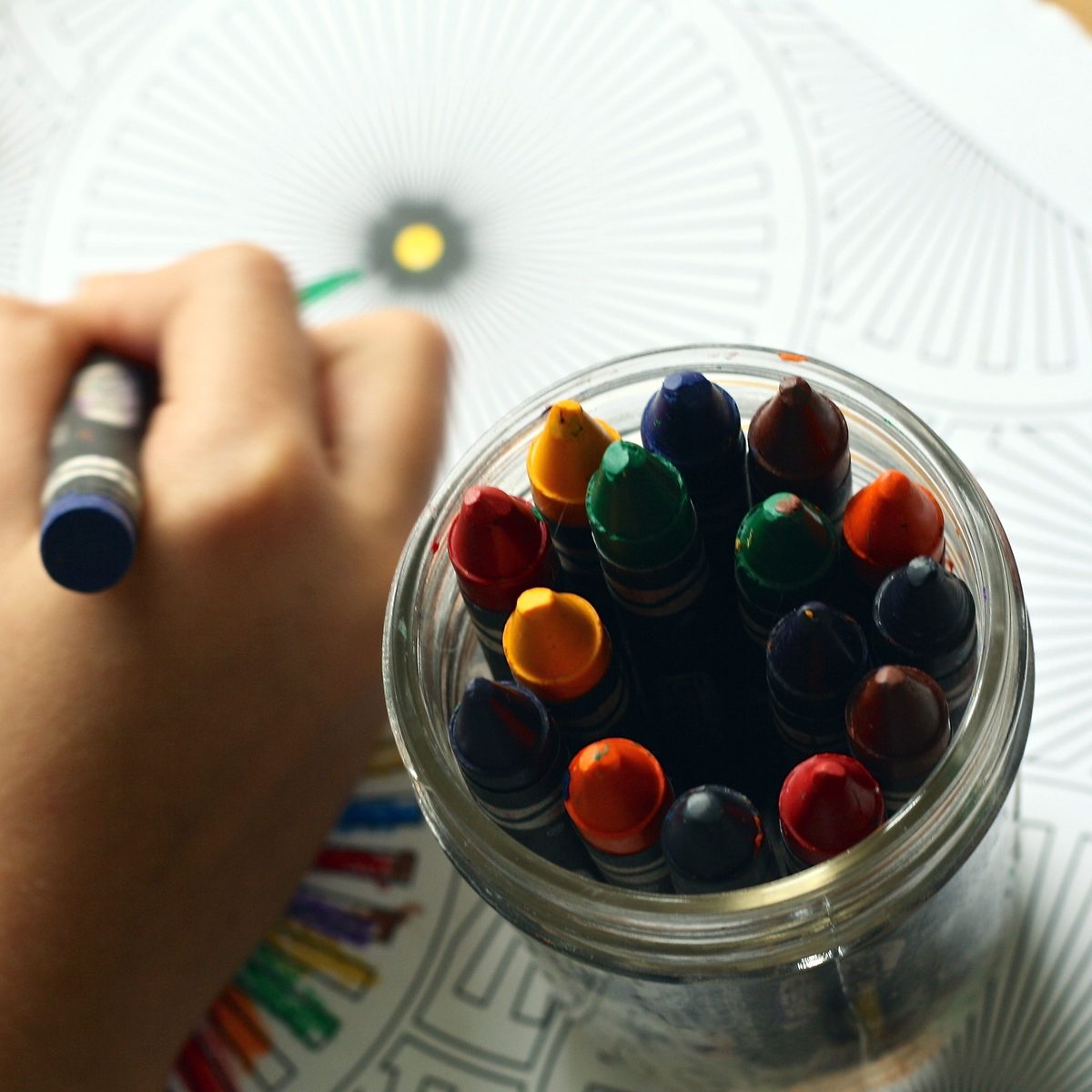 A jar of colourful crayons ready for drawing